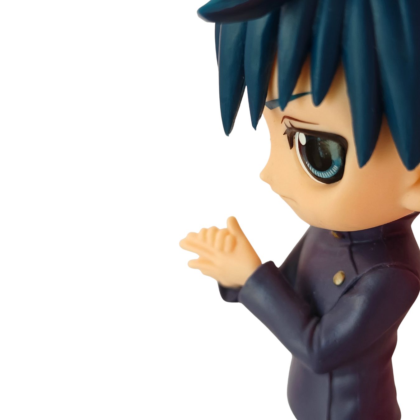 A close-up side profile of an anime-style collectible figure with dark blue hair, a large expressive eye, and a dark navy uniform, shown against a plain white background.