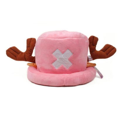 A plush tony chopper toy hat in pink with brown reindeer antlers and a white embroidered X on the front, photographed against a plain white background.