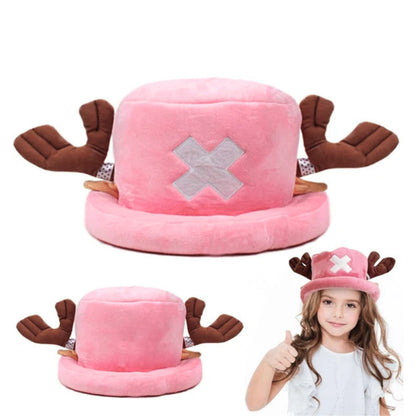 A plush pink hat with brown reindeer antlers and a silver X emblem, shown from the front and side, with a young girl wearing it and giving a thumbs-up on a white background.