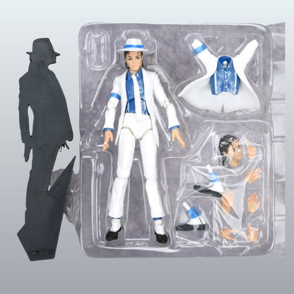 A Michael Jackson action figure in its clear plastic blister packaging, shown alongside a black silhouette accessory on a gray gradient background.