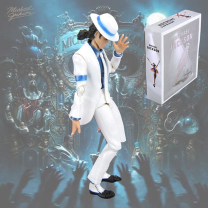 Michael Jackson figure in a white suit with blue accents, posed next to its retail box against a stylized concert backdrop with blue lighting and raised hands.