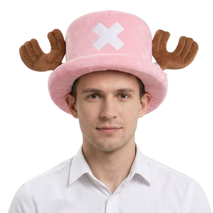 A man wearing a pink plush hat with brown antler-like side pieces and a white X emblem on the front, photographed against a plain white background.